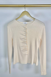 Front view of a rouched in the buttons cream long sleeve knitted top