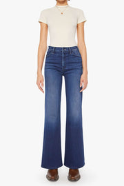 Front view of a person wearing a blue, wide leg, high rise, and clean hem jean