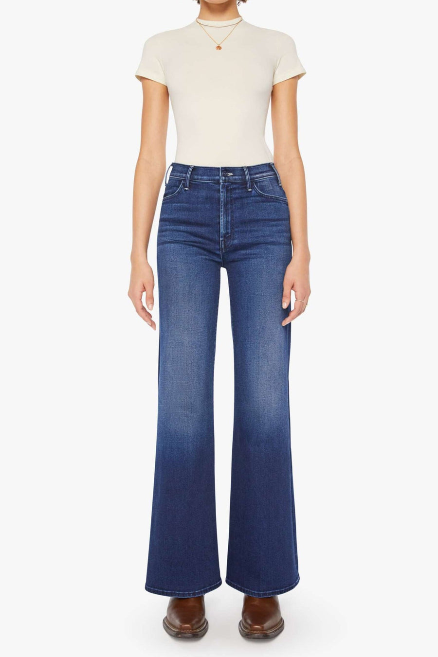 Front view of a person wearing a blue, wide leg, high rise, and clean hem jean