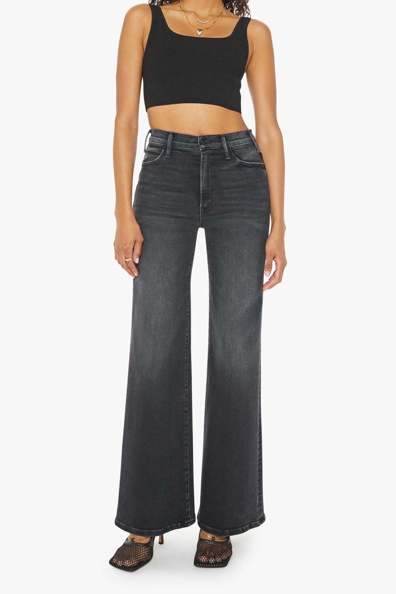 Front view of a person wearing a washed black, wide leg, high rise, and clean hem jean