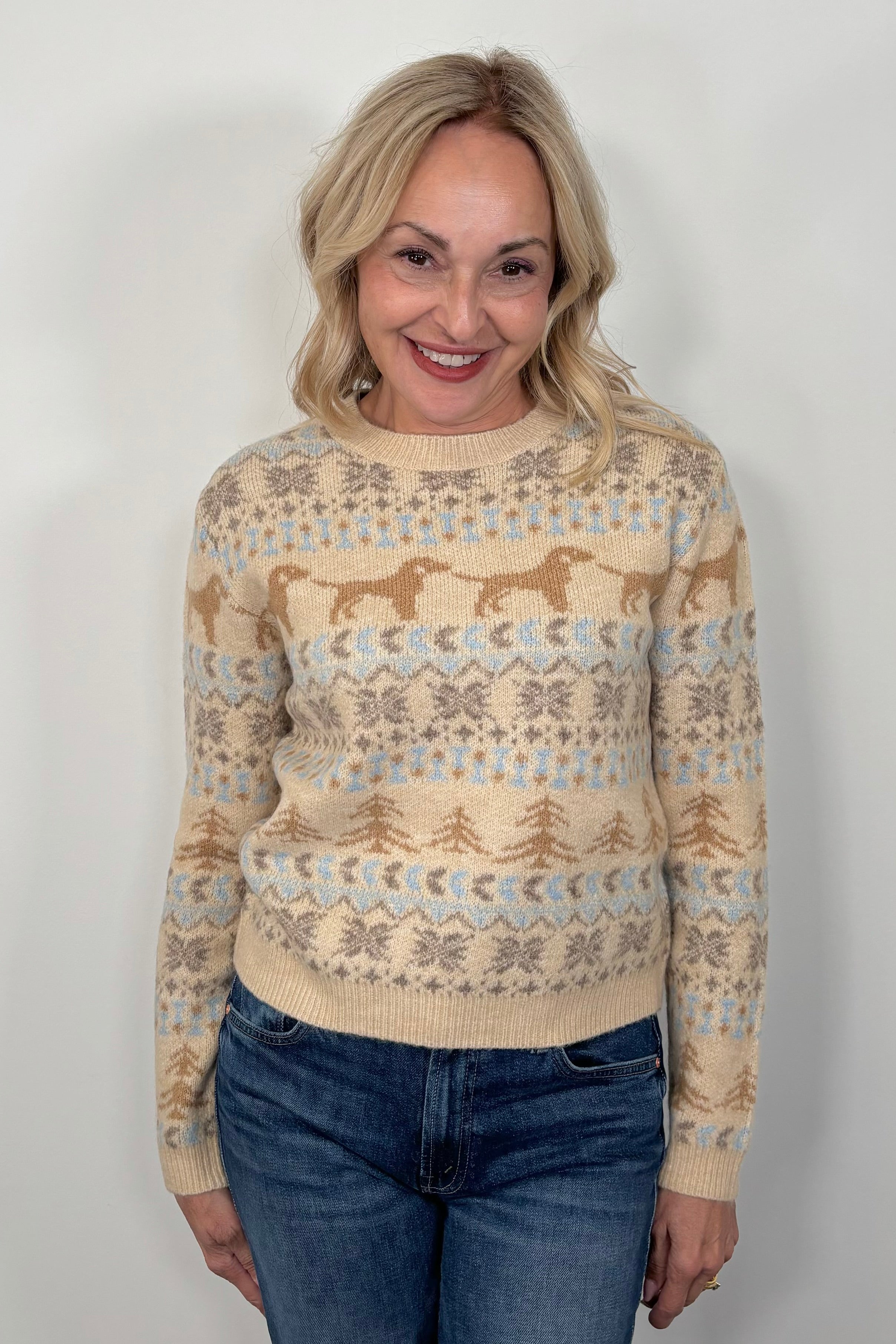 Woman wearing a patterned sweater against a plain background