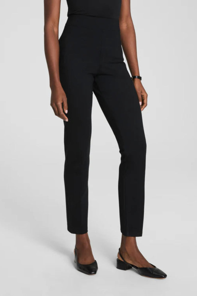 Person wearing black pants on a white background