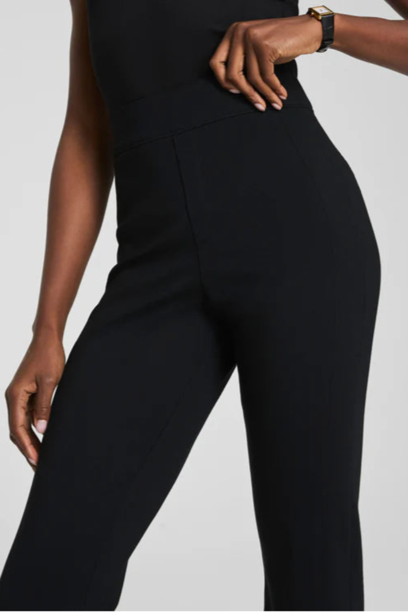 Person wearing a black pants on a plain background