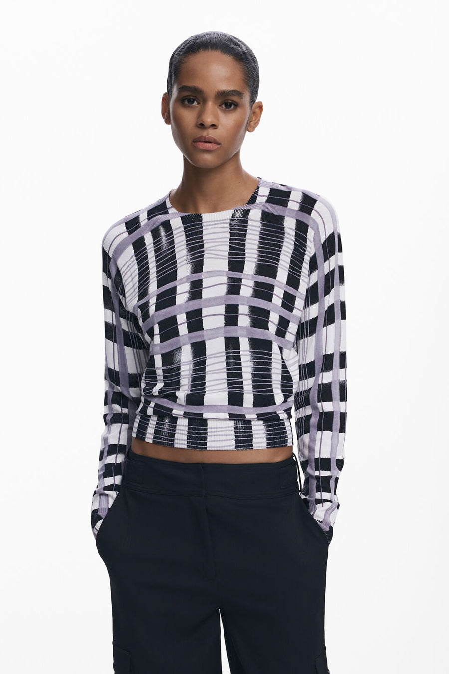 Front view of woman wearing a light-weight plaid black, white and lilac sweater