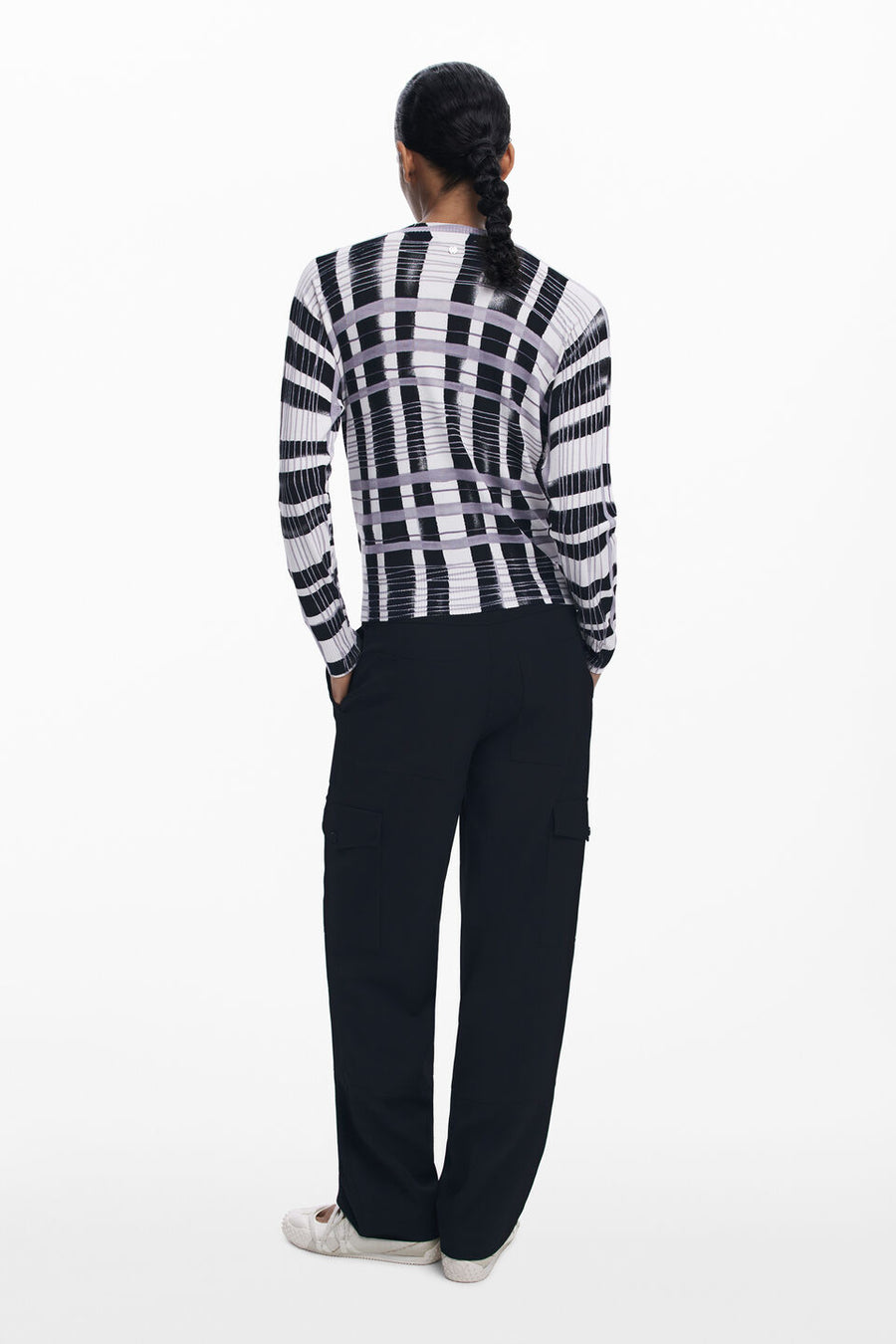 Back  view of woman wearing a light-weight plaid black, white and lilac sweater