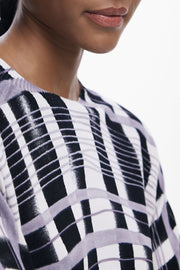 Close-up of a light-weight plaid black, white and lilac sweater's pattern