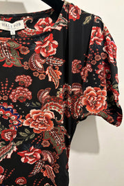 Close up view of a midi dress with floral and paisley pattern