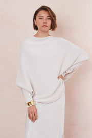Woman wearing a white off the shoulder sweater