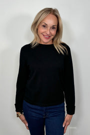Front view of woman wearing a cashmere long sleeve black shirt