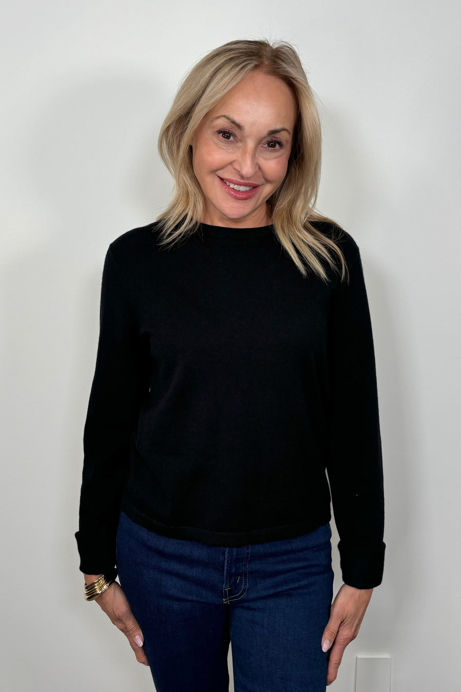 Front view of woman wearing a cashmere long sleeve black shirt