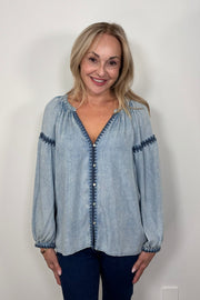 Front view of woman wearing a blue tencel blouse with stitch detailing