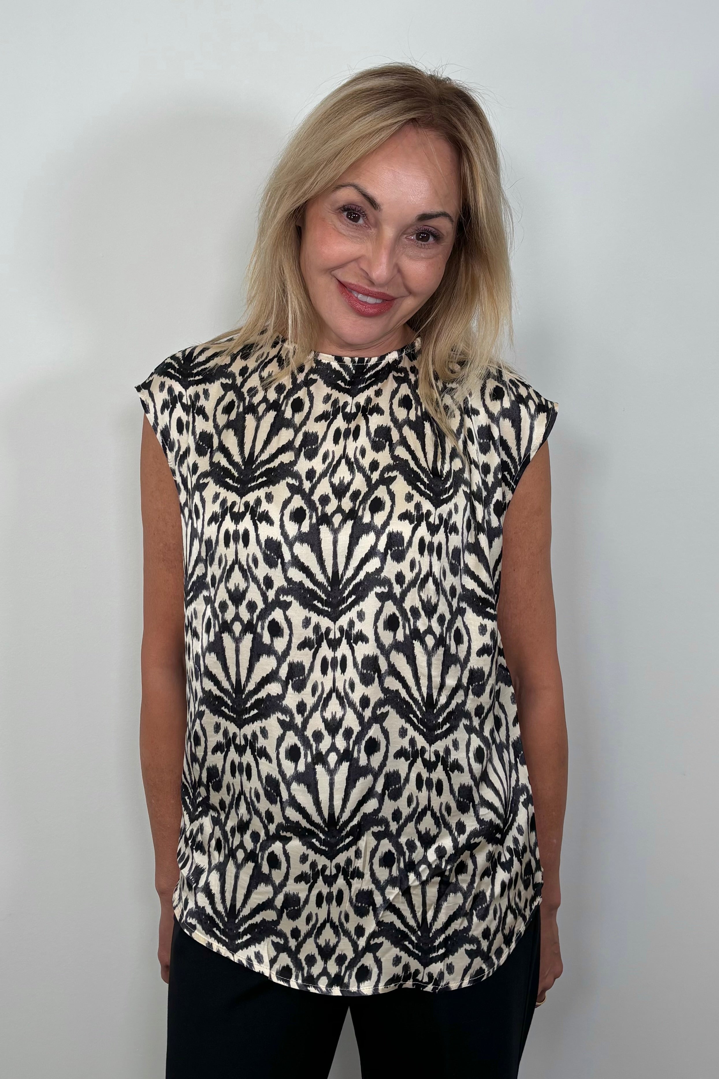 Front view of woman wearing a printed Satin sleeveless top