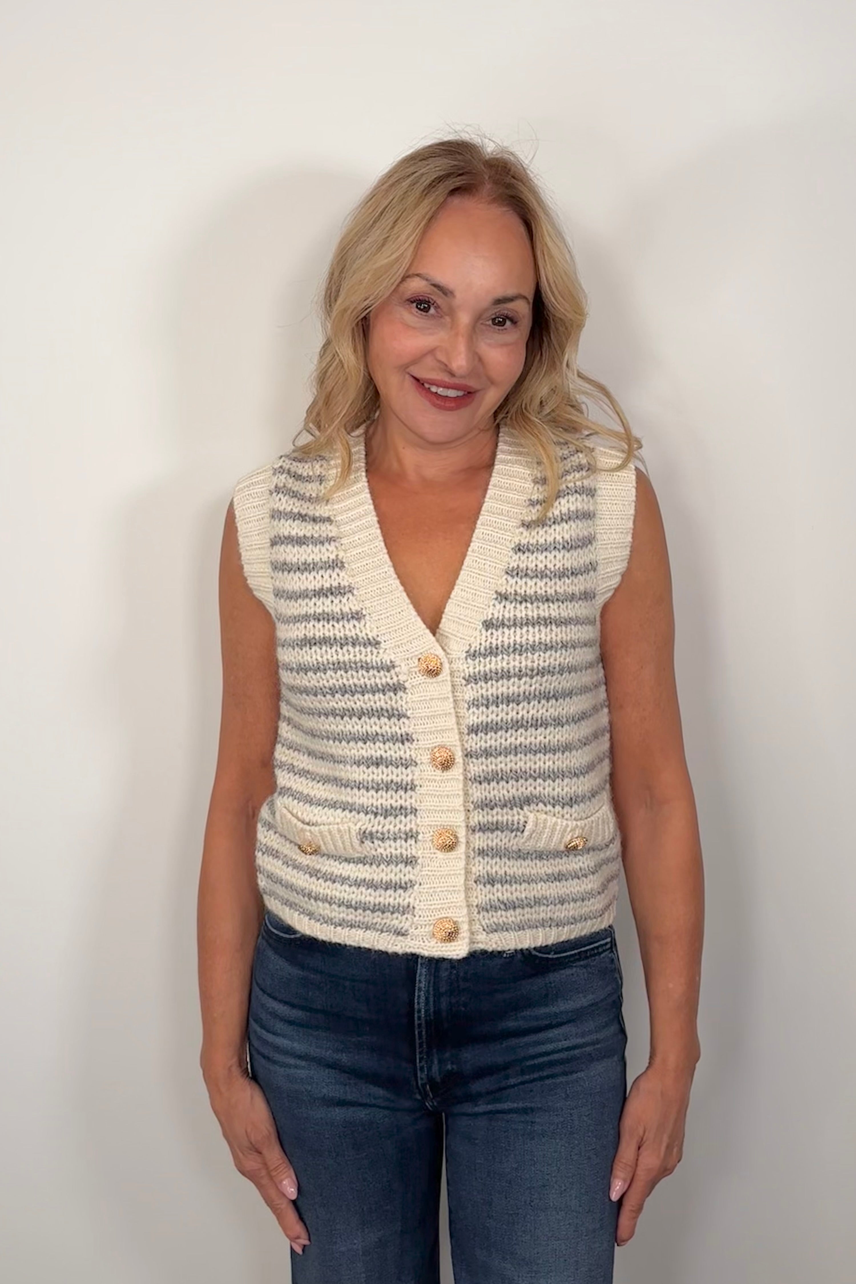 Front view of woman wearing a knitted striped vest