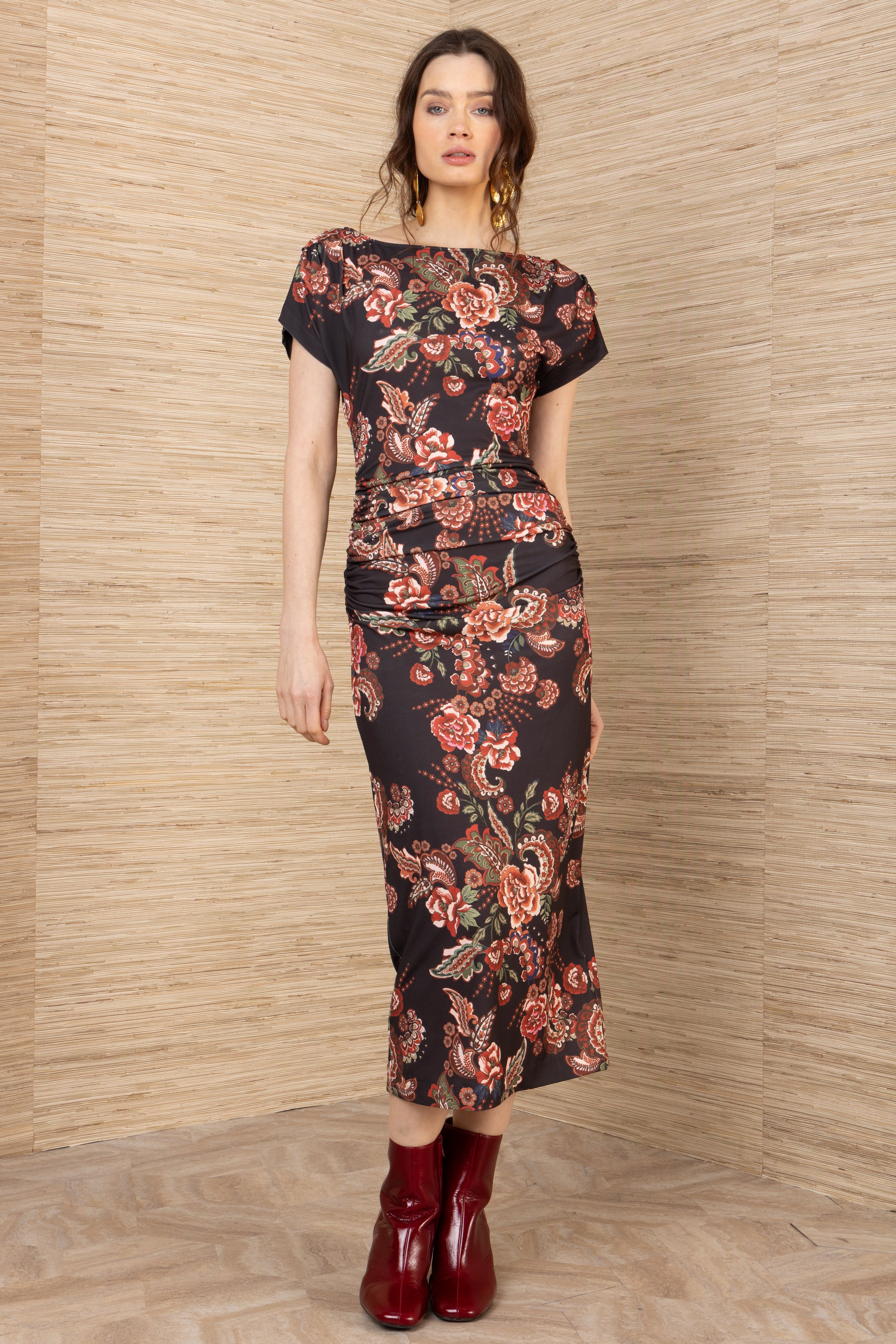 Front view of a woman wearing a black midi short sleeve mesh dress with red floral pattern