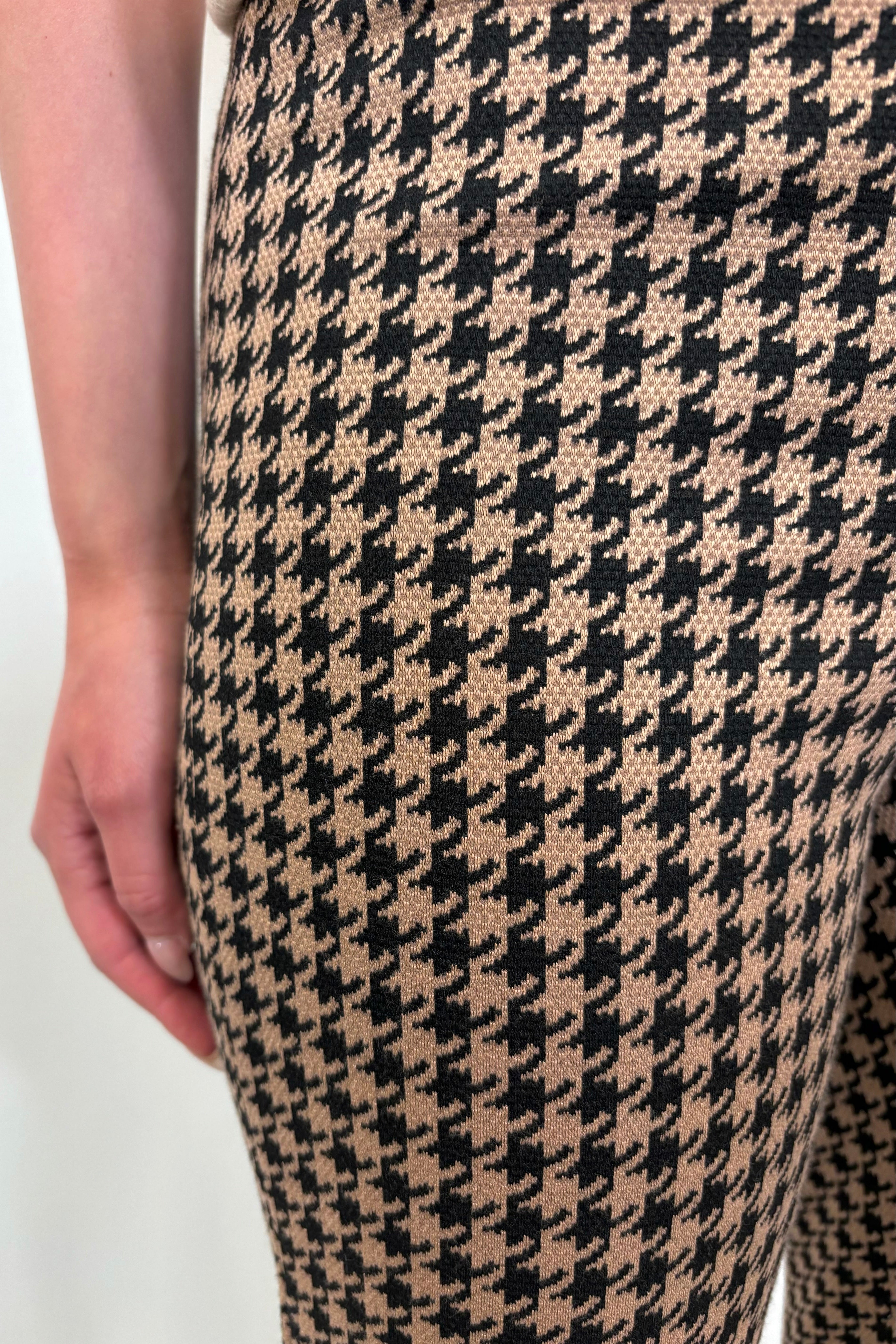 Close up view of woman wearing a houndstooth knit pant