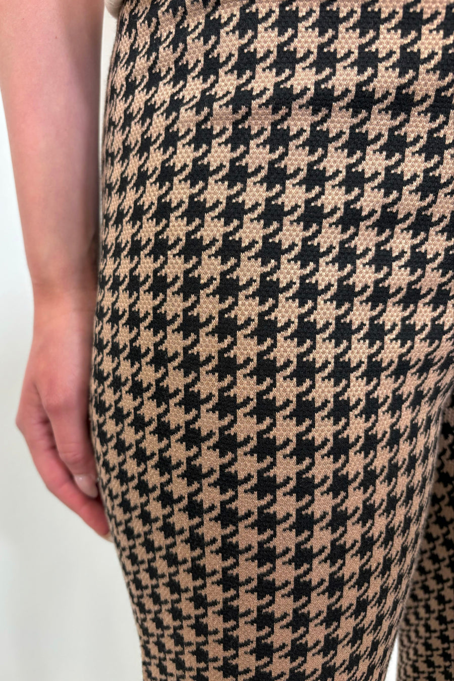 Close up view of woman wearing a houndstooth knit pant
