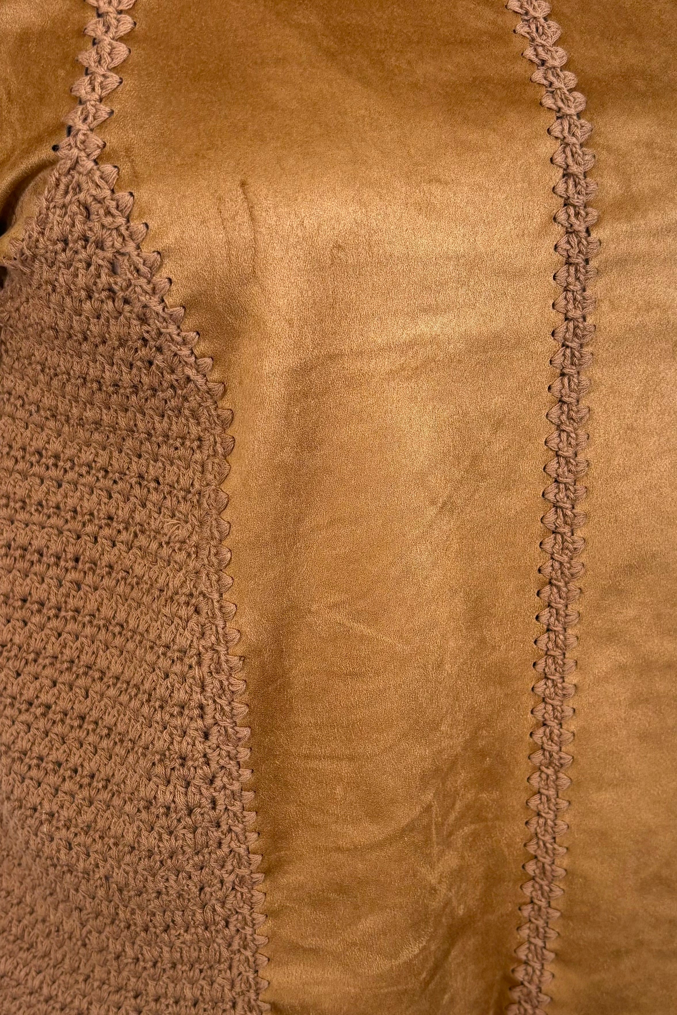 Close-up of a suede leather and crochet top