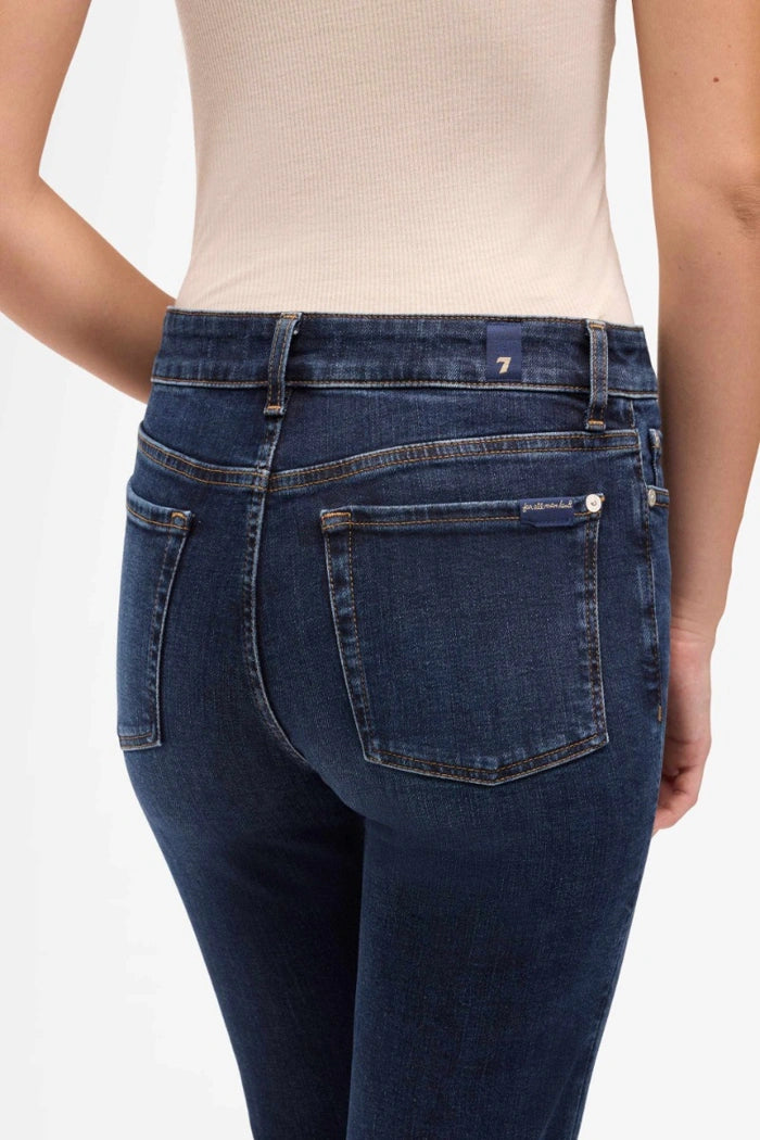 Person wearing blue jeans on a white background