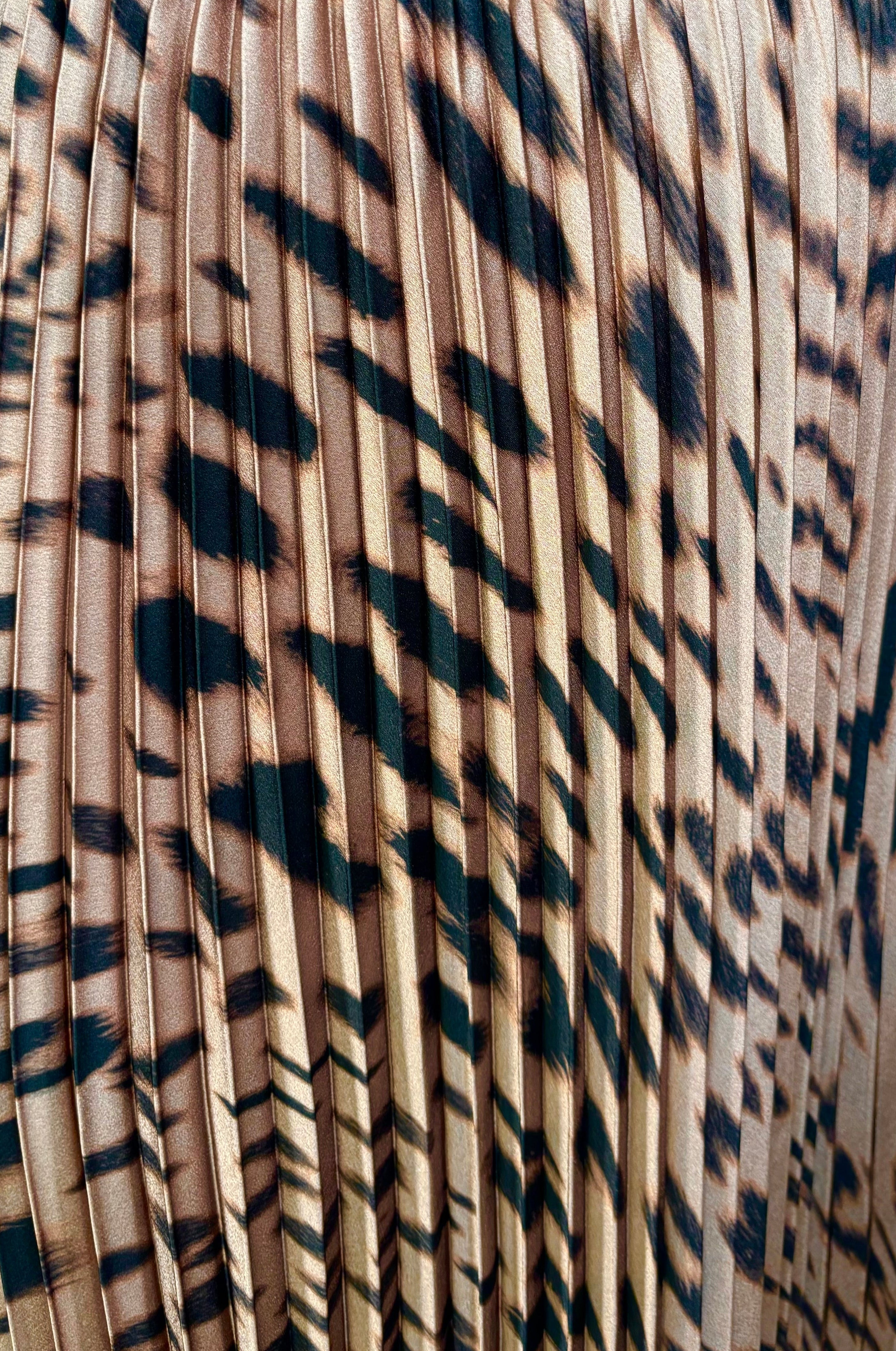 Close up view of a woman wearing a leopard printed midi skirt