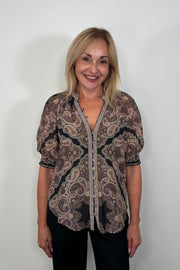 Front facing woman wearing a cotton and silk blend black half sleeve top with a light brown pattern