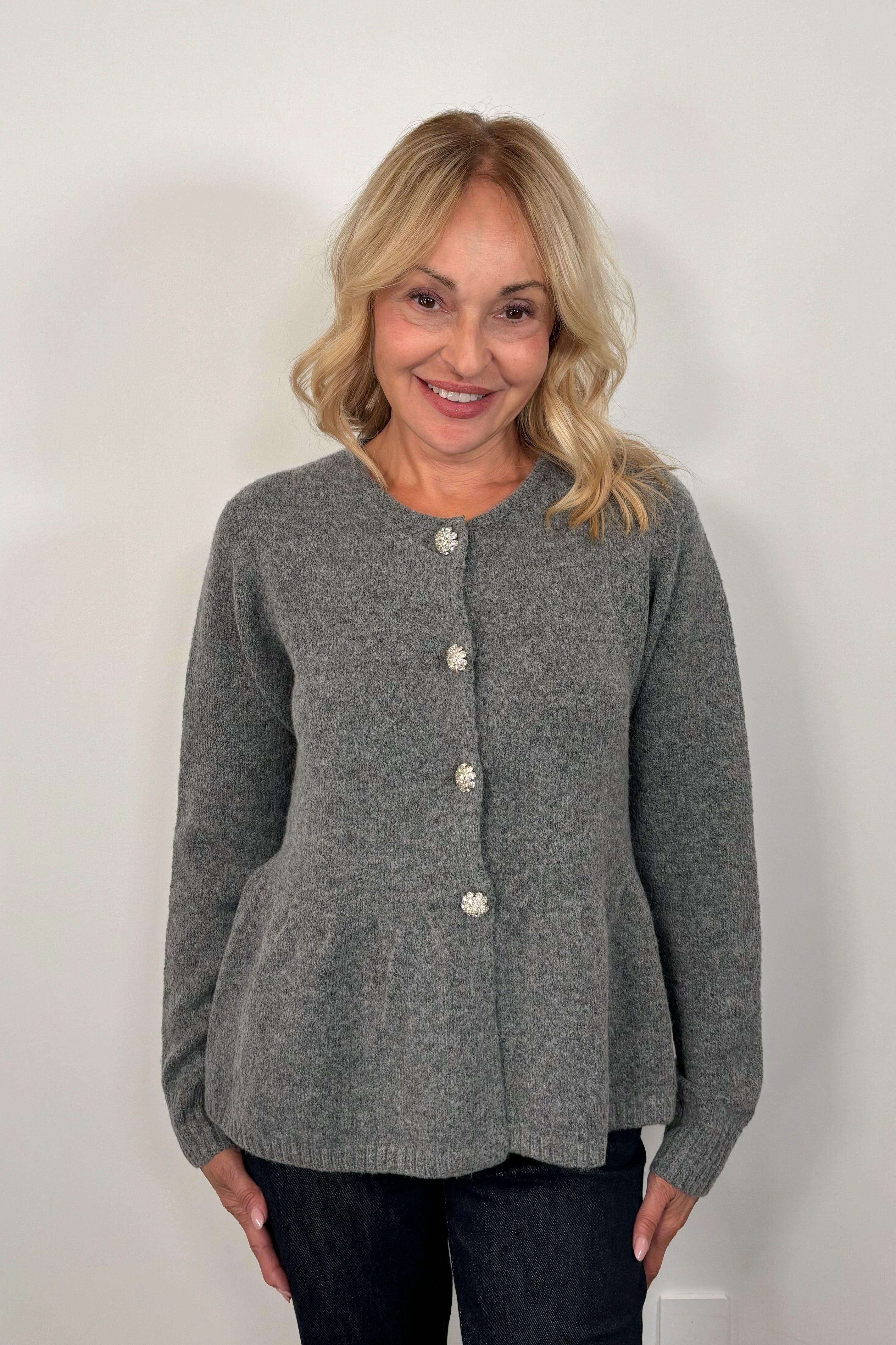 woman wearing a gray  peplum cardigan