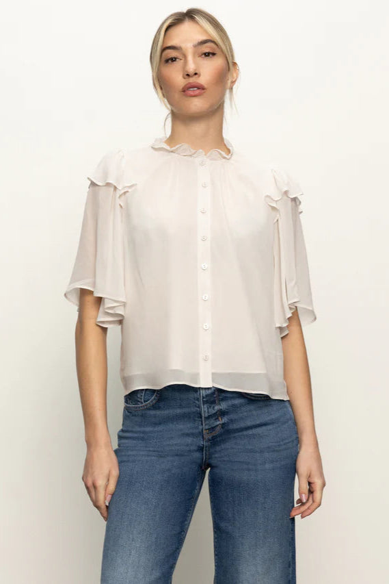 Front view of woman wearing an oat coloured light blouse