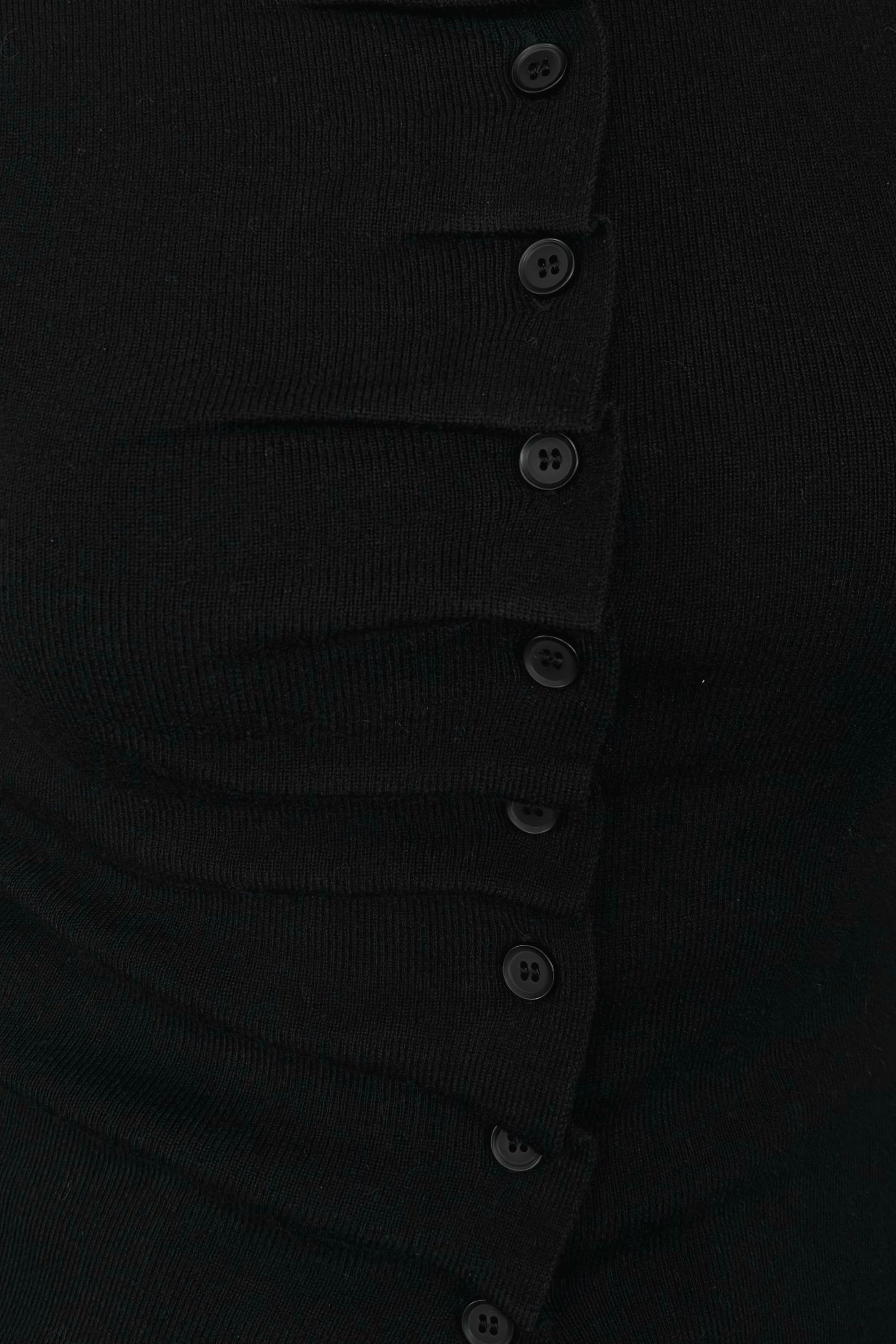 close-up of a black rouched front knit top
