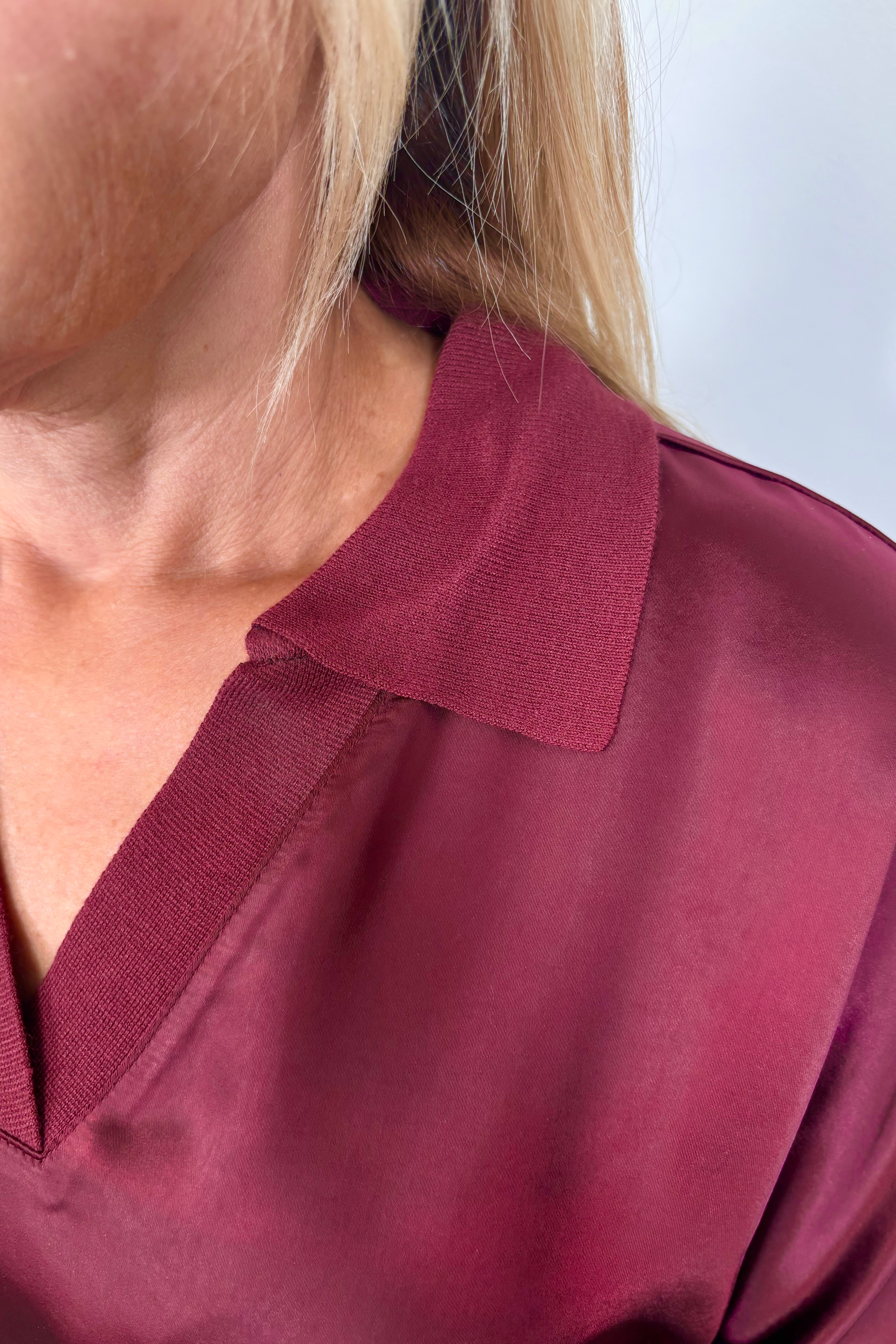 Close-up of the neck of a satin mix long sleeve top