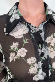 Close-up view of a black mesh floral shirt