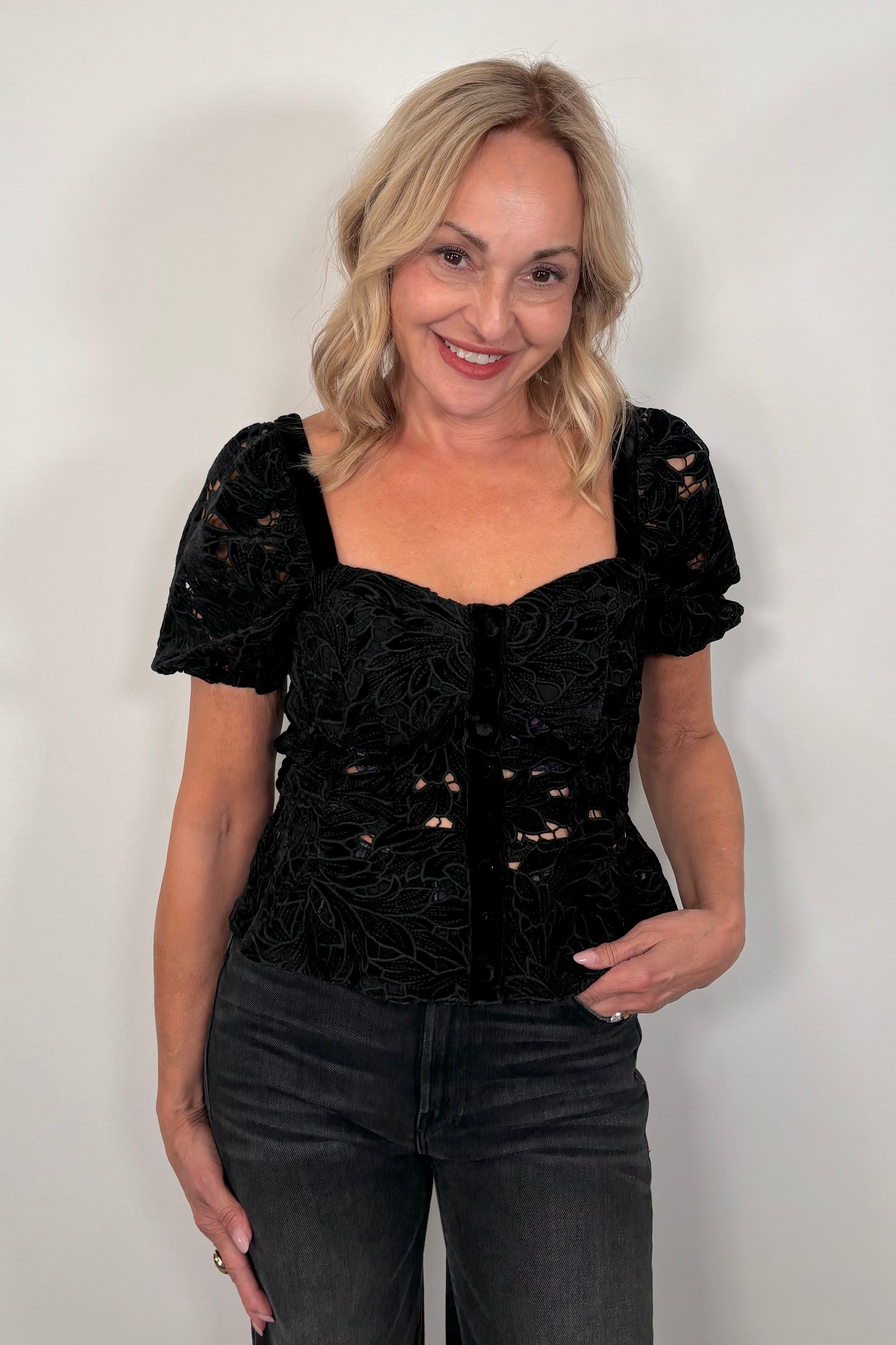 Woman wearing a black lace top