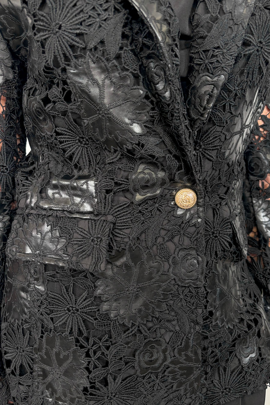 Close-up of a vegan leather lace blazer