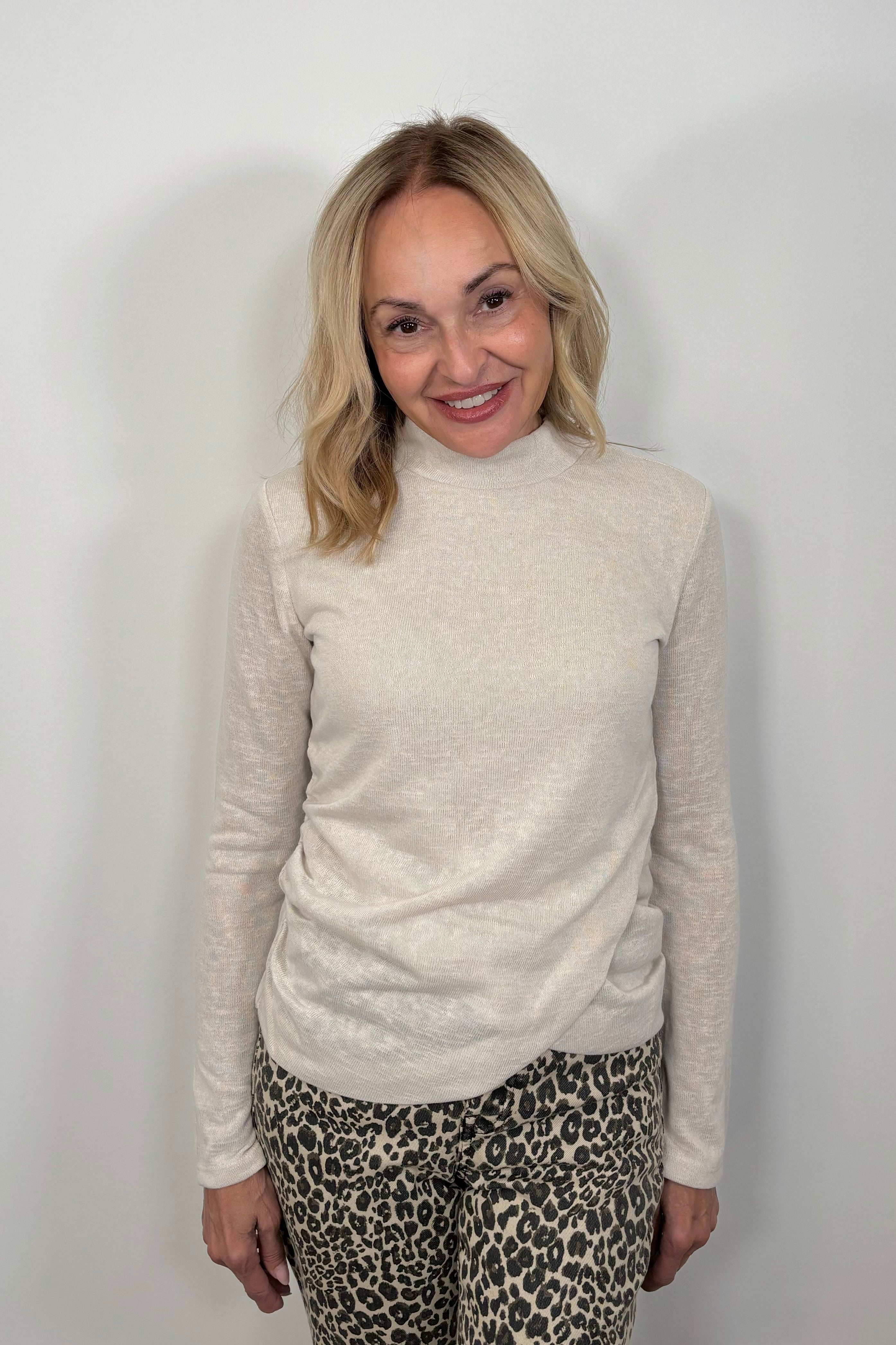 woman wearing a light long sleeve draped beck top