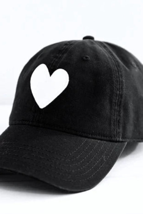 Black cap with a white heart design on a white background