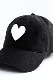 Black cap with a white heart design on a white background