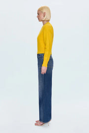 Person wearing a yellow sweater and blue jeans on a white background