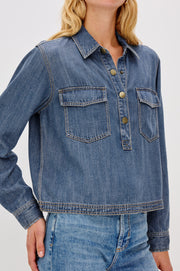 Close up of a relaxed blue denim long sleeve shirt