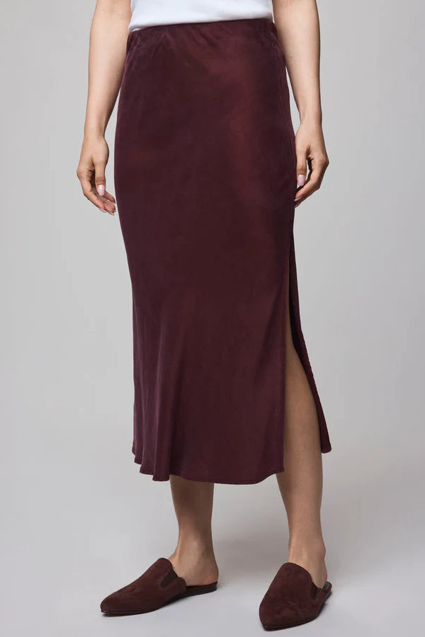 Person wearing a burgundy skirt with a white background