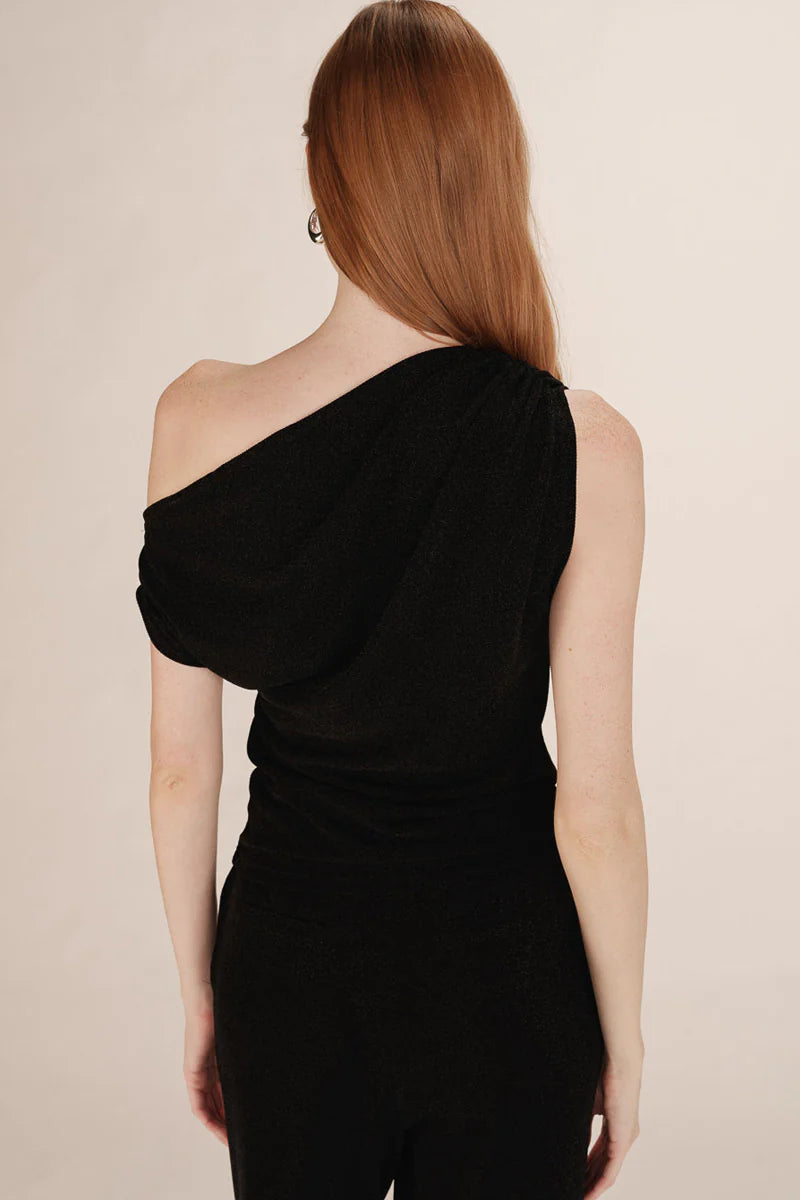 Woman wearing a black one-shoulder top
