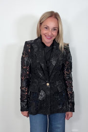 Video of a woman wearing a vegan leather lace blazer