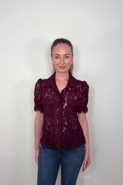 Video of woman wearing a button down short sleeve lace blouse