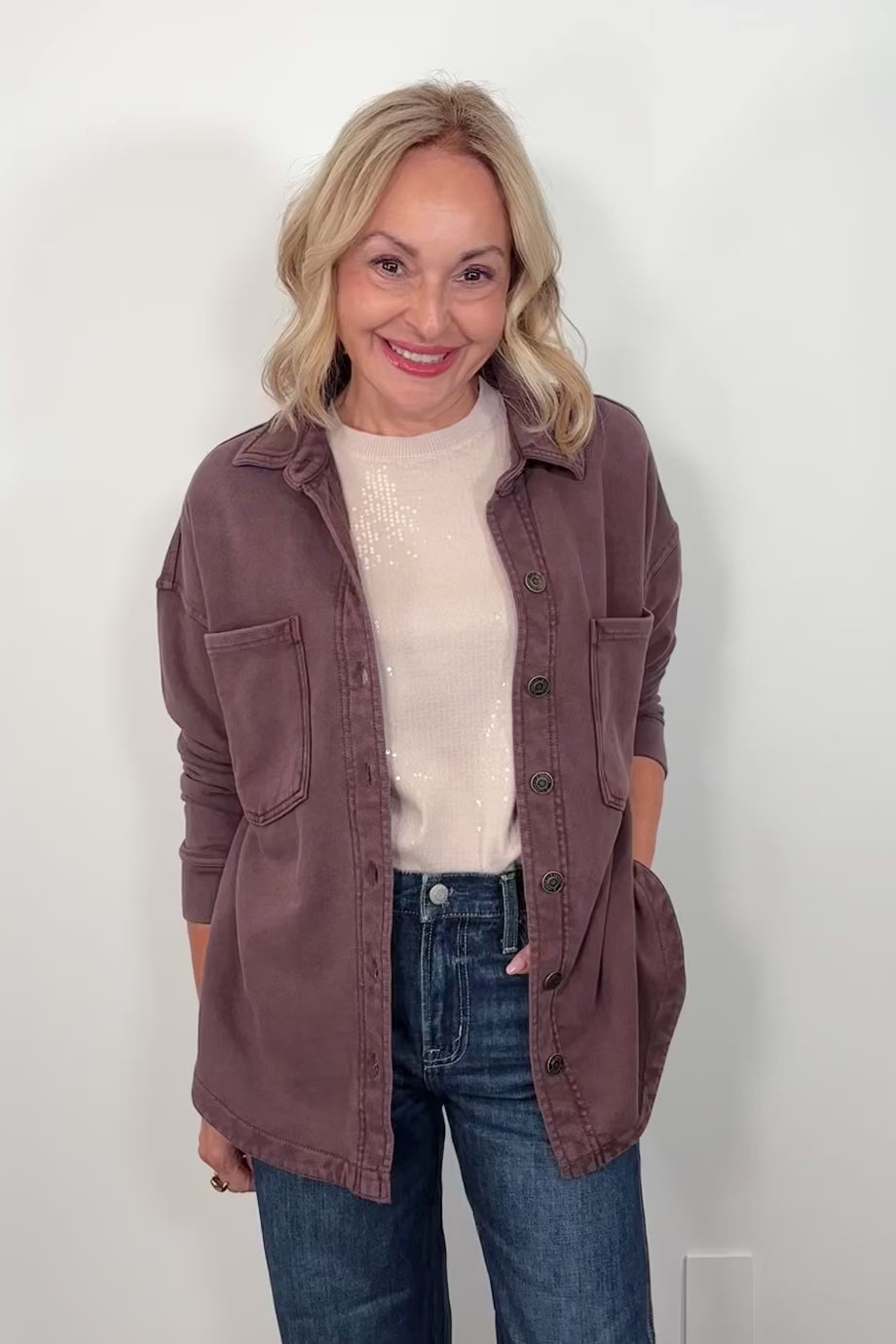 video of a woman wearing a brown jacket
