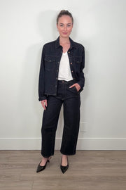 video of a woman wearing dark wash denim jacket with matching crescent jeans
