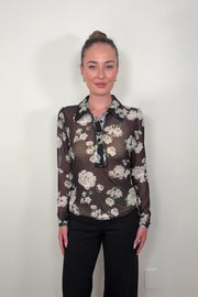 Video of a woman wearing a black mesh floral shirt