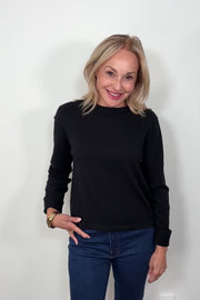 Video of woman wearing a cashmere long sleeve white shirt