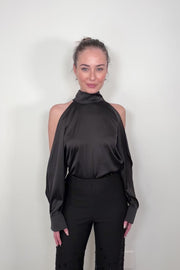 Video of woman wearing a black satin off-shoulder halter top