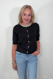 Video of a woman wearing a half sleeve black cardigan with crystal detailing