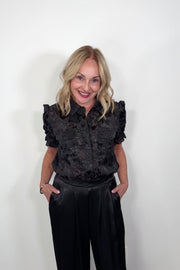 Video of a woman wearing black burnout short sleeve shirt