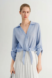 Woman wearing a blue button up shirt