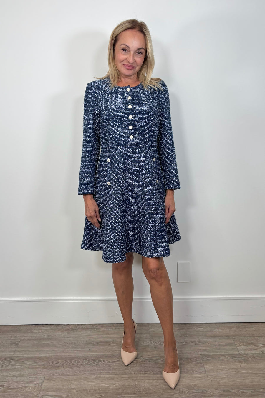 Front view of woman wearing a blue tweed short dress