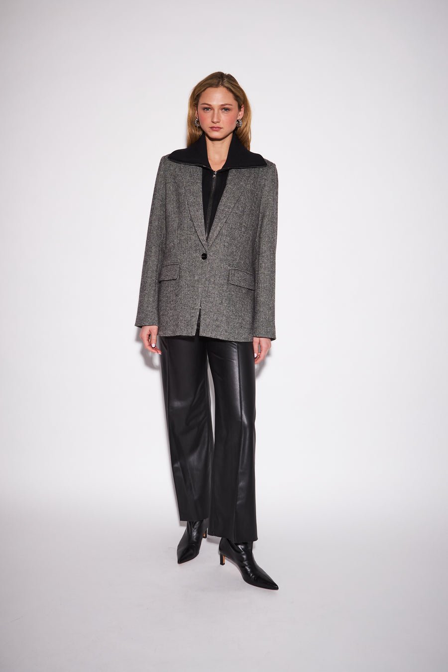 model wearing a black and white textured tweed blazer with a tailored fit